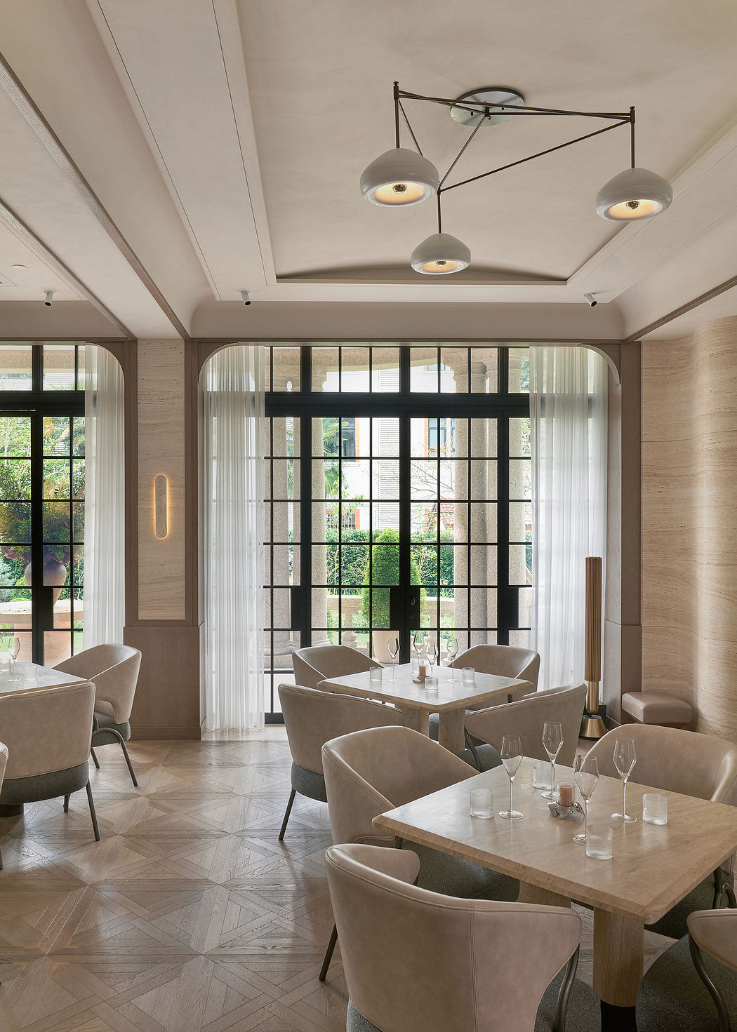 Elegant dining area with modern pendant lighting, large windows, and a sophisticated decor.