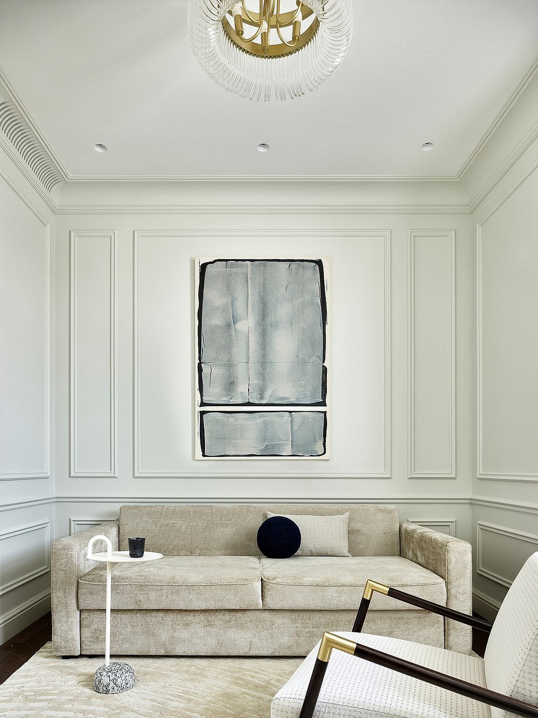 Elegant living room with ornate ceiling, built-in paneling, and modern furnishings.