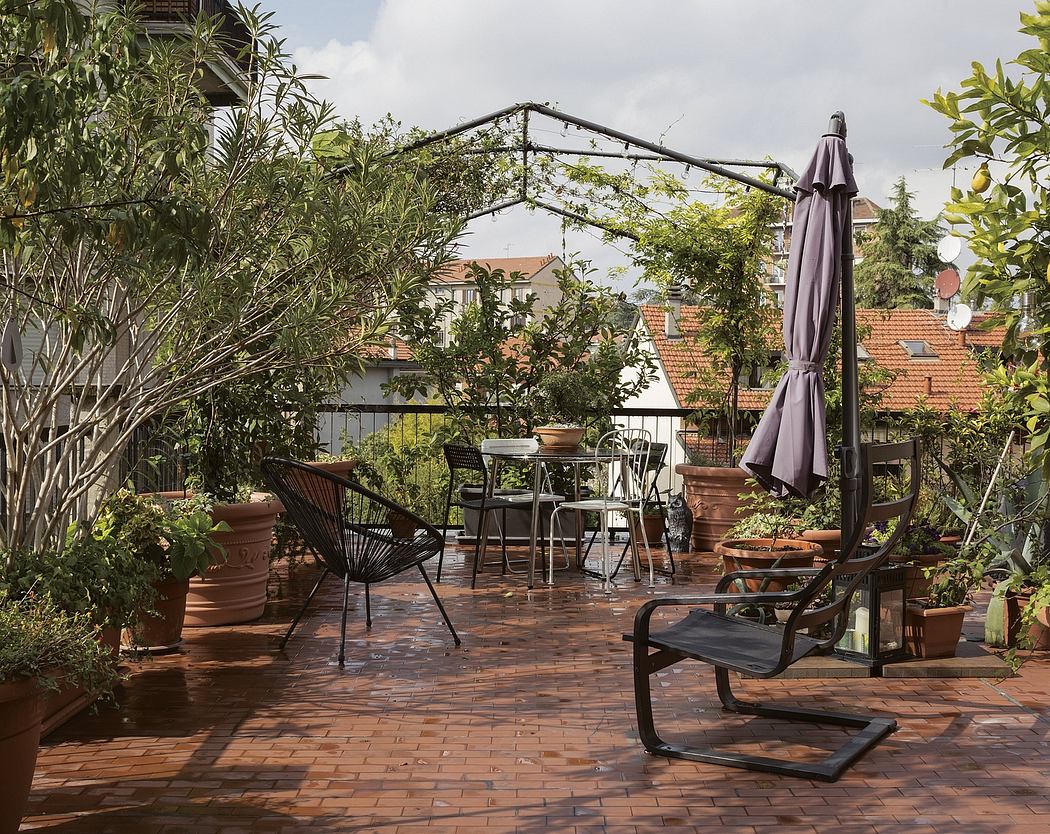 A lush, green outdoor patio with a wrought-iron pergola, brick flooring, and potted plants.