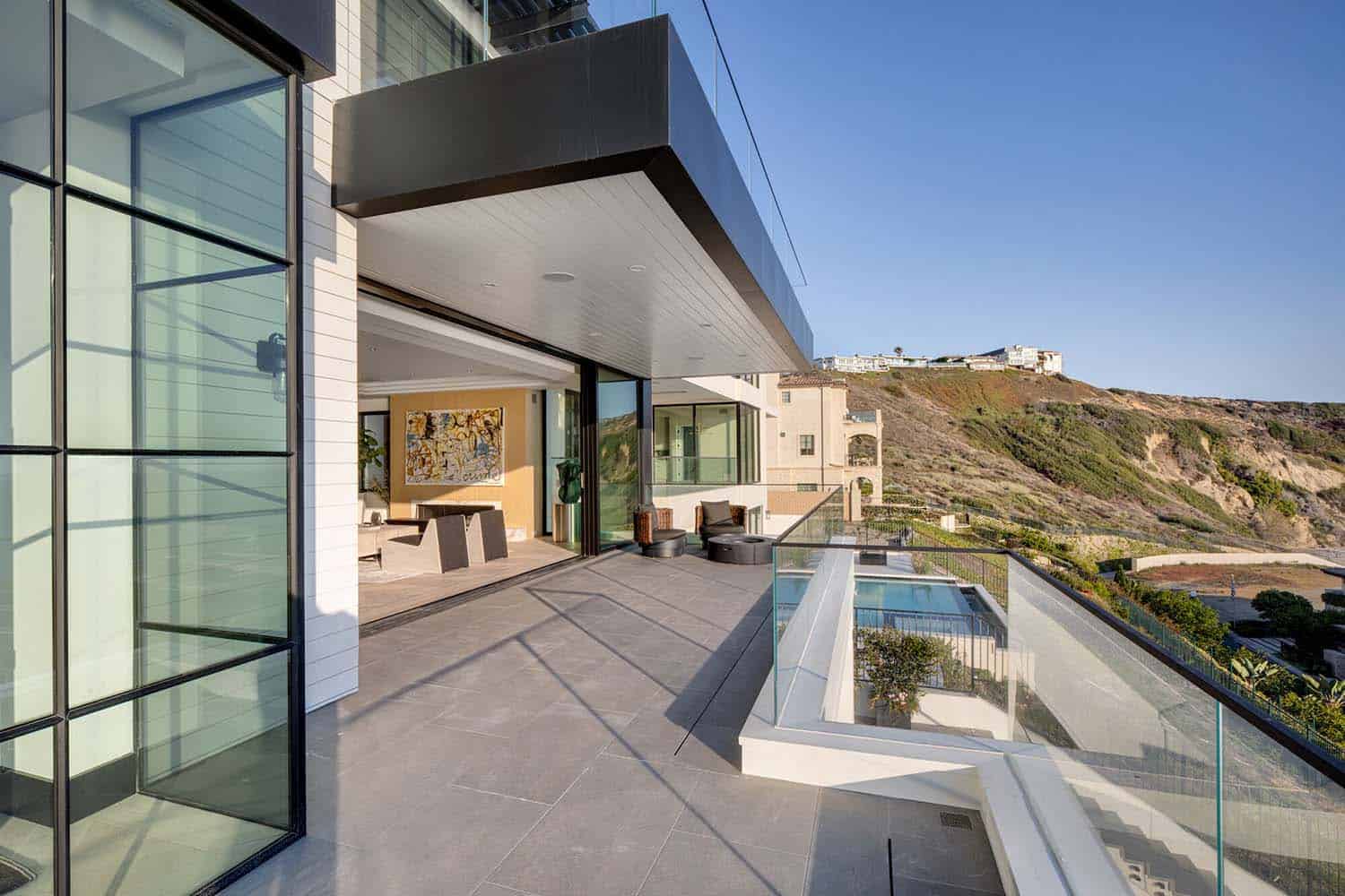 coastal contemporary patio with a swimming pool