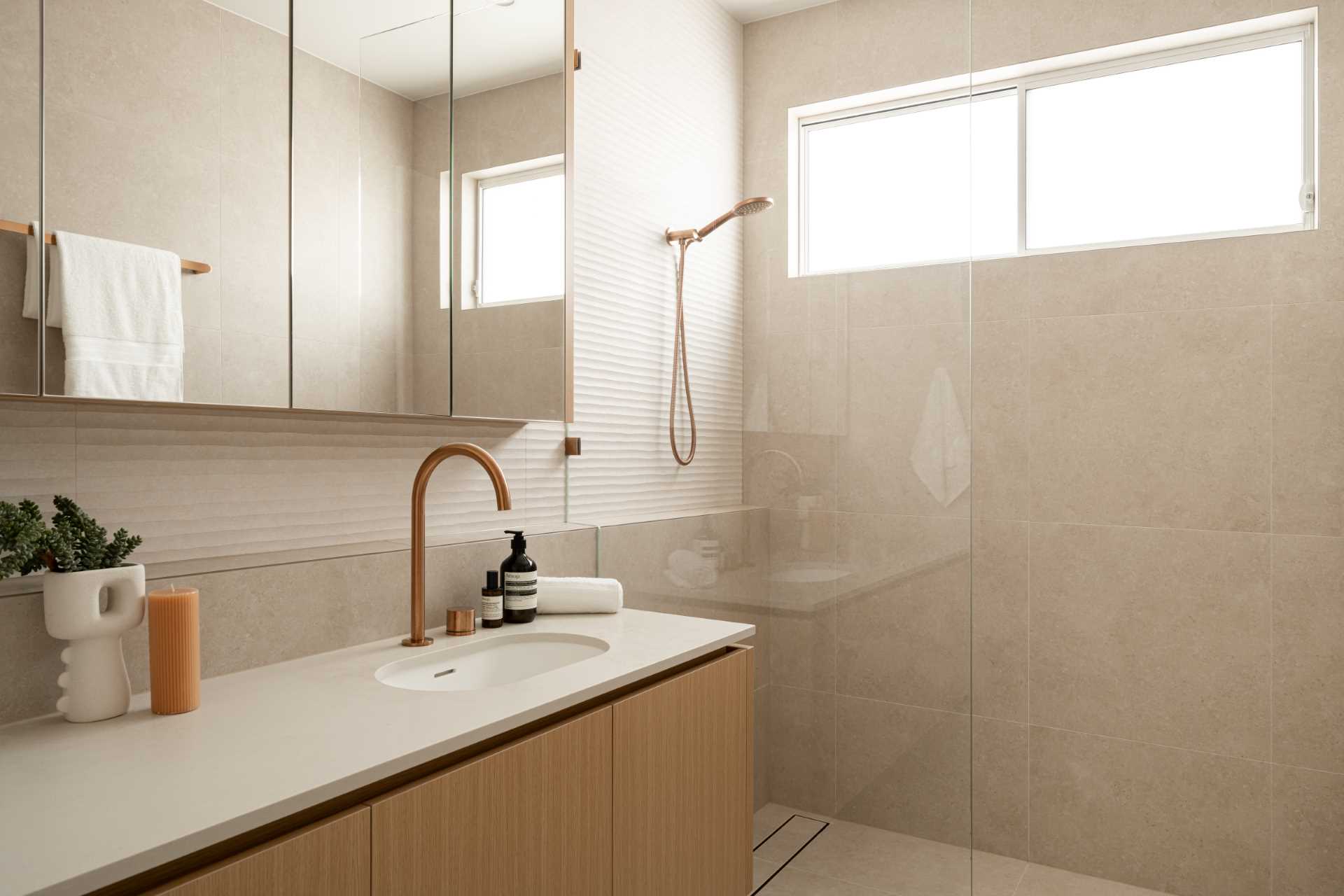 A contemporary bathroom has a shower with a shelving ledge.