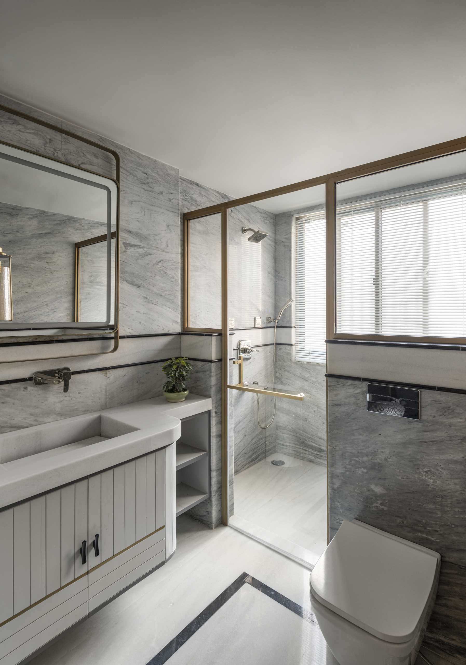 A contemporary bathroom with gold accents.