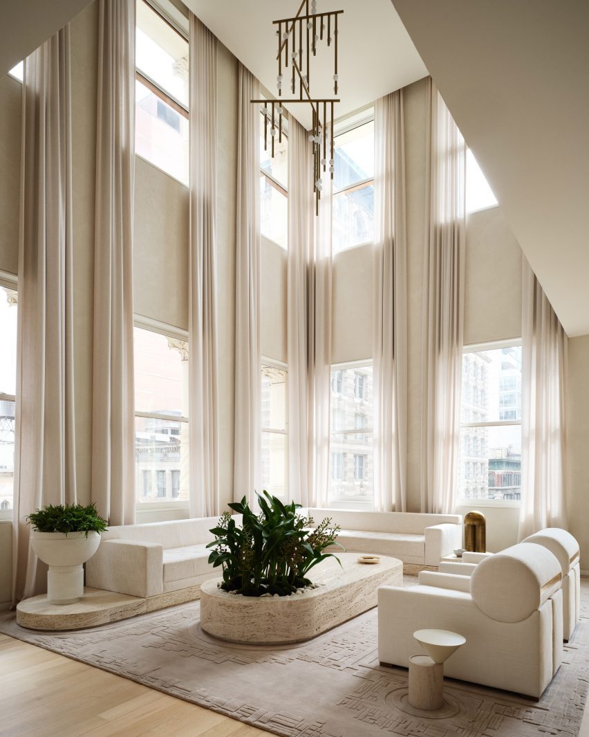 Double-height living room surrounded by windows