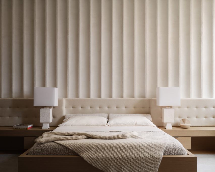 A fluted feature wall behind a bed