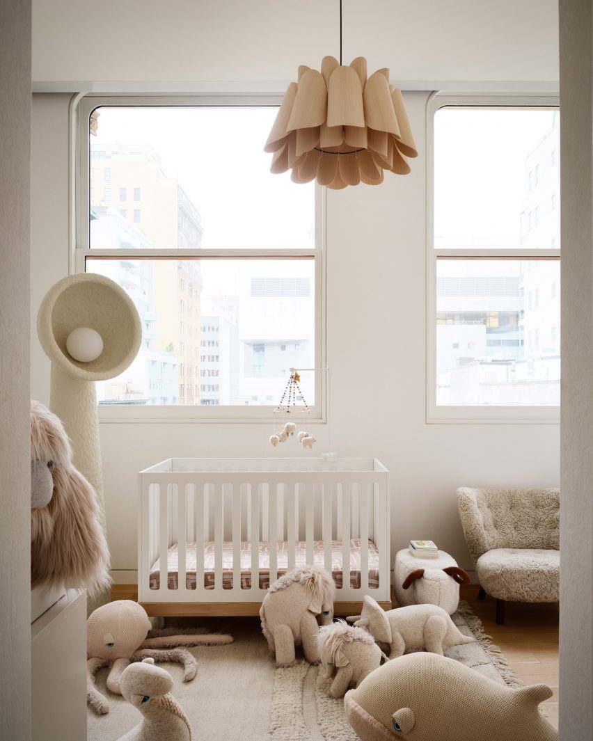 Neutral-coloured nursery with soft toys on the floor