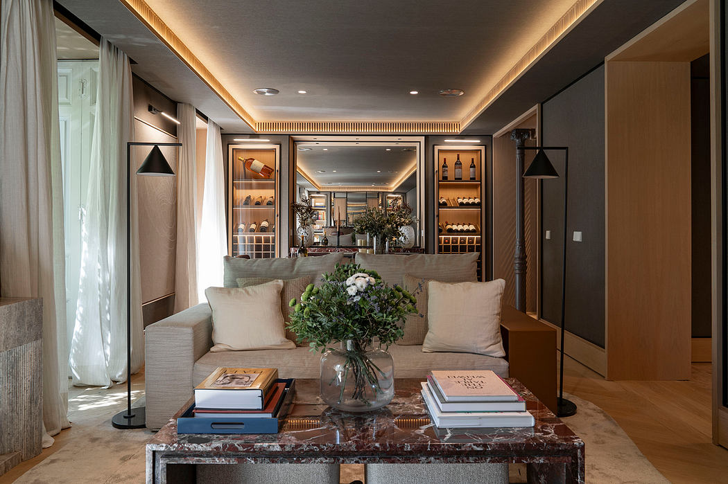 Luxurious living room with contemporary furniture, marble coffee table, and built-in shelves.